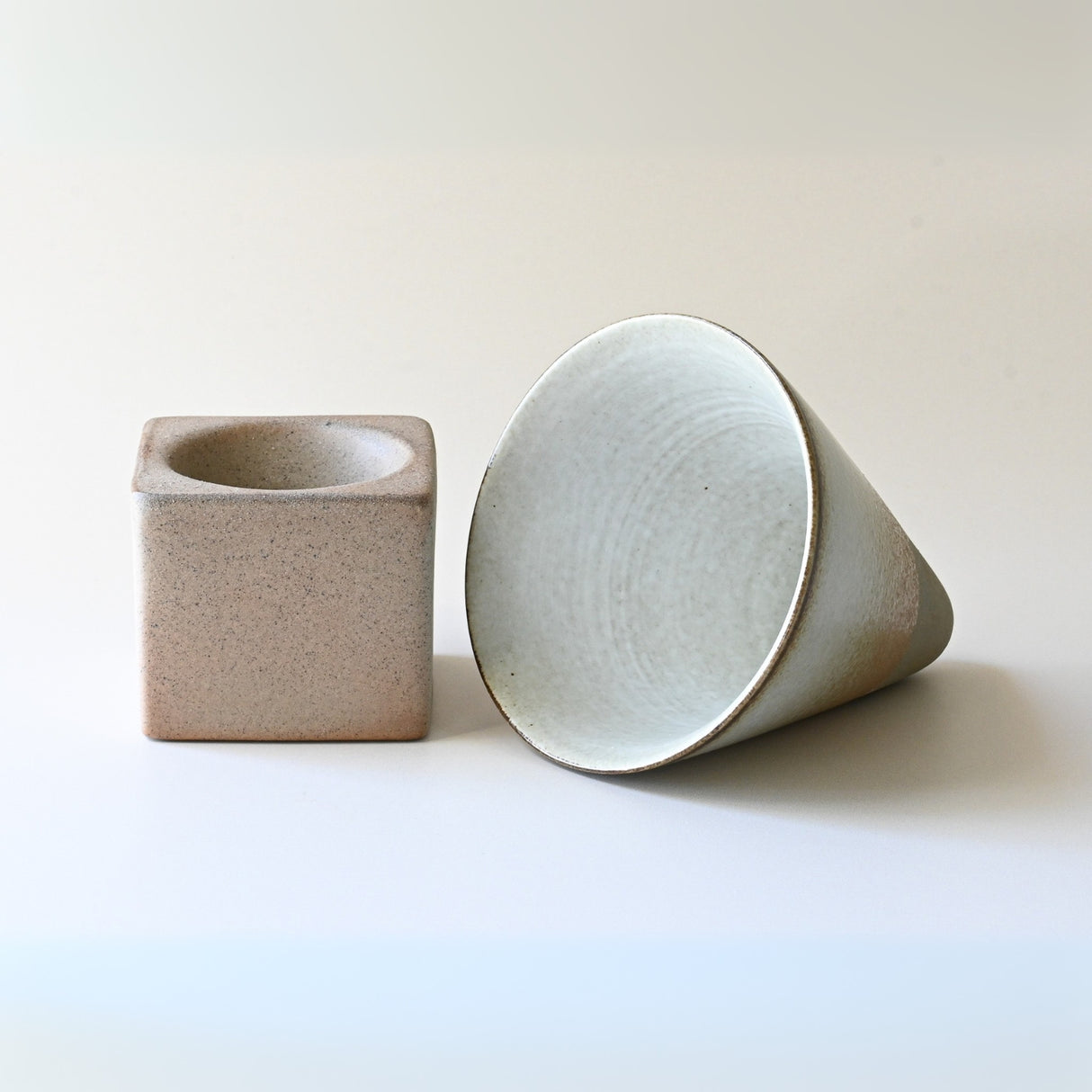 A brown coffee mug with a base, holding 6.8 oz (200ml), is presented against a plain background, highlighting the timeless artistry of ceramic design.