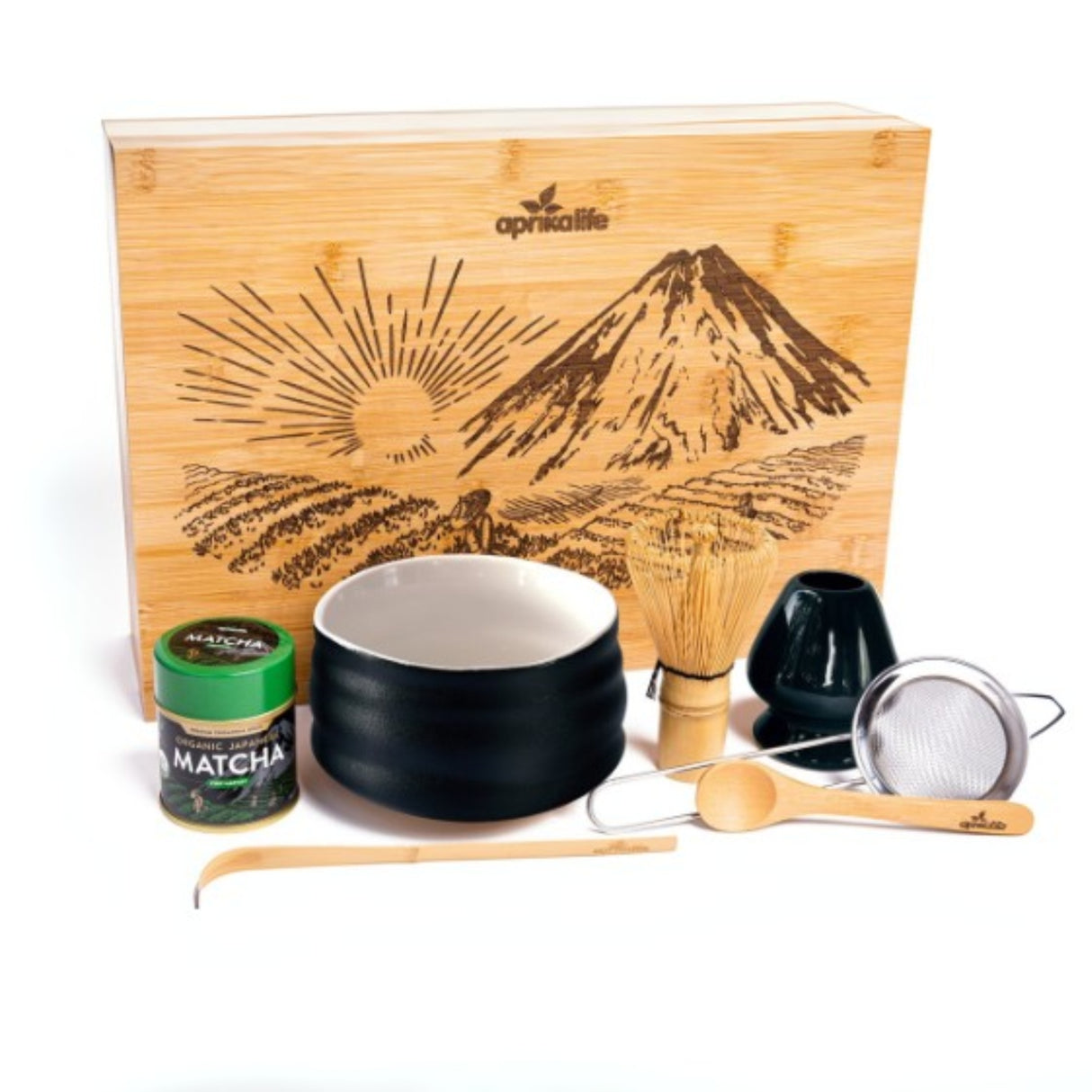 The Black Matcha Tea Gift Set includes a bamboo whisk, bowl, scoop, sifter, matcha container, and a wooden box with an elegant mountain design—ideal for tea lovers seeking an authentic experience.