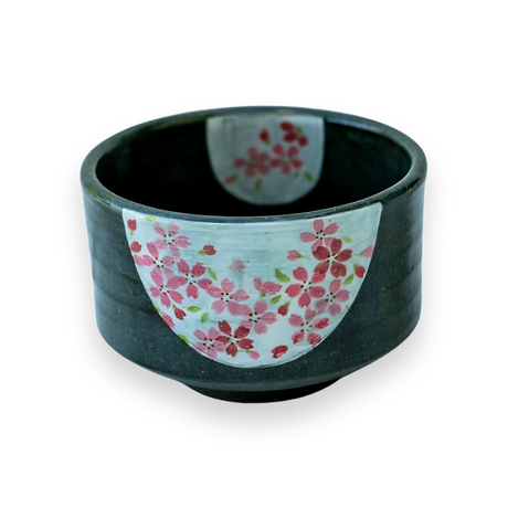 The Dark Grey Flowers Ceramic Matcha Bowl features elegant craftsmanship with its dark ceramic base and pink cherry blossom design on a white background.