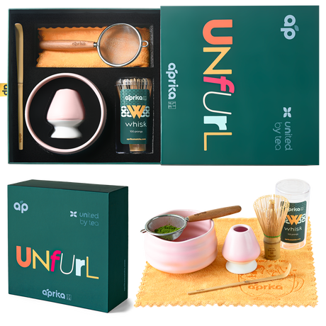 The "Ceremonial Matcha Starter Kit - Pink" includes a beautifully crafted ceramic matcha bowl, a bamboo whisk, and a sifter, all elegantly packaged in a green box by "aprika.