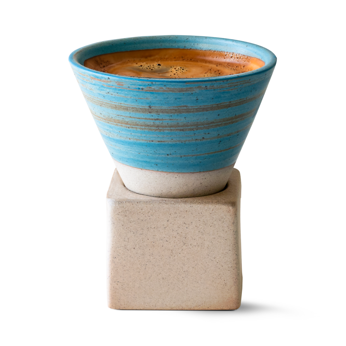 A Blue Coffee Mug with Base - 6.8 oz/200ml, adorned with blue stripes and filled with rich coffee, sits on a square stone stand against a white background.