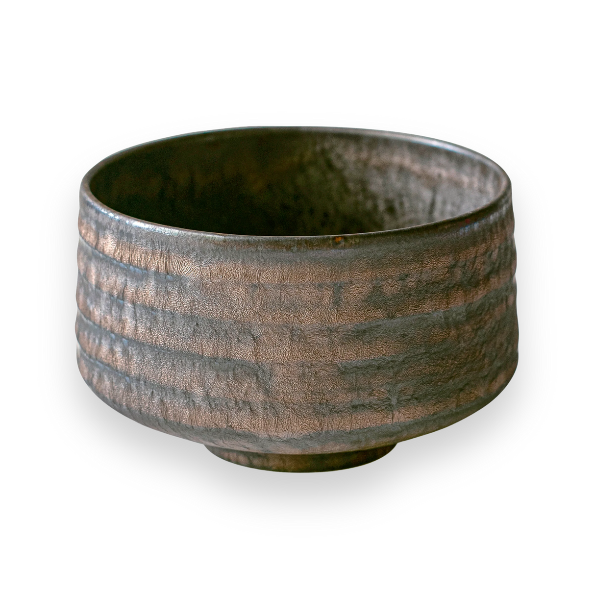 A rough-textured, dark gray ceramic bowl with a slightly metallic finish on a black background, highlighting craftsmanship similar to Japanese pottery, reminiscent of the Kaneni Gold Crystal Ceramic Matcha Bowl.