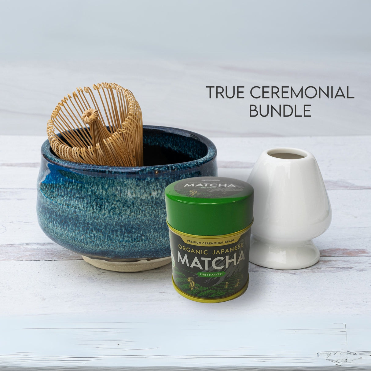 Maruyoshi Navy Sea Ceramic Matcha Bowl set includes a bamboo whisk, matcha tin, and white holder, all on a clean white surface.