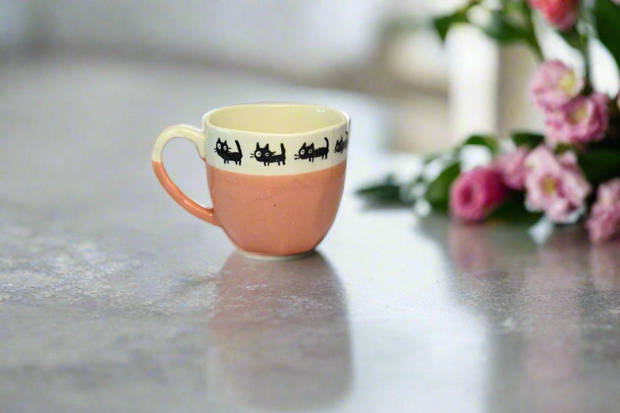 The Handmade Pink Ceramic Mug with Black Cats Print from Japan (8oz/250ml) adds playful charm to your table, making tea or coffee time special.