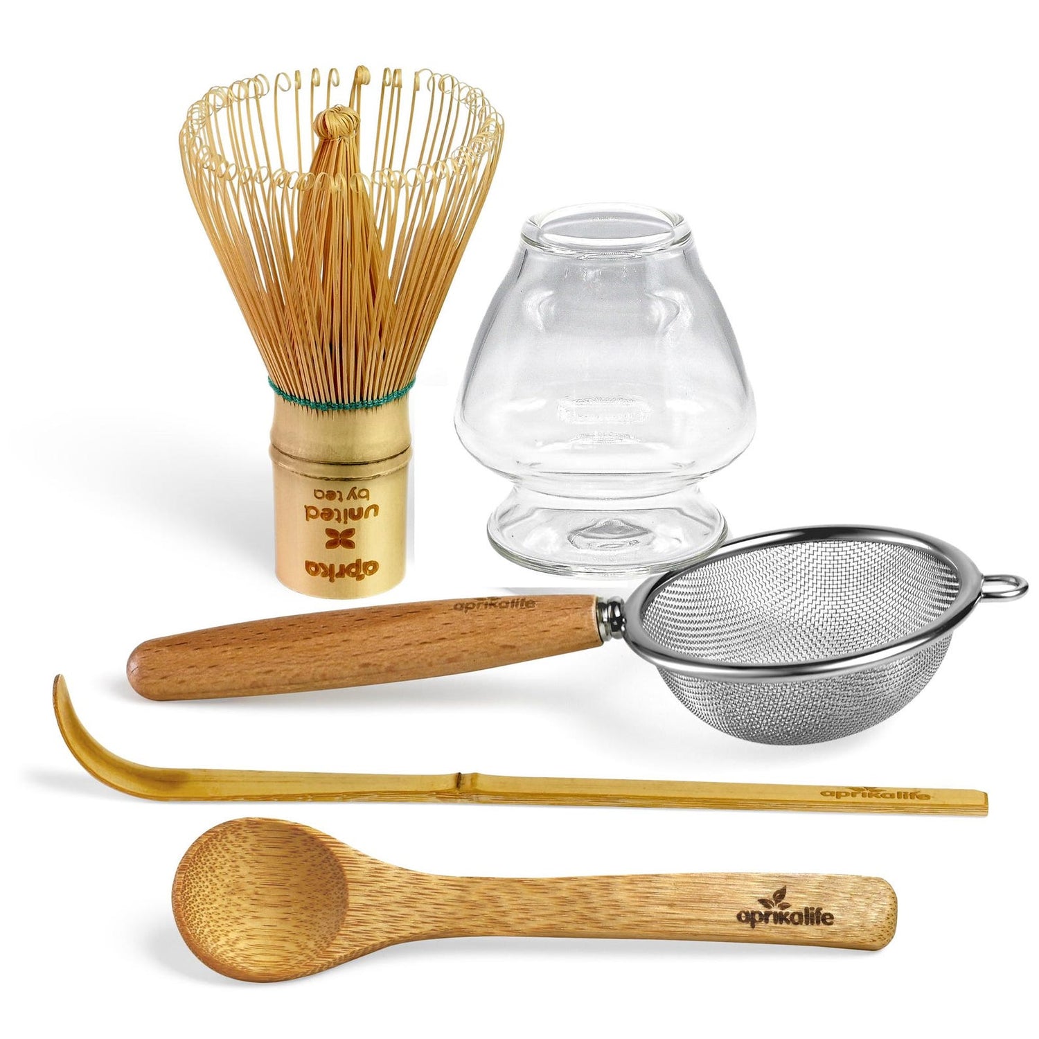 The Clear Glass Matcha Whisk Holder and Bamboo Whisk Set includes a bamboo whisk, glass whisk holder, borosilicate glass bowl, metal strainer, bamboo spoon, and scoop for expertly preparing matcha tea.