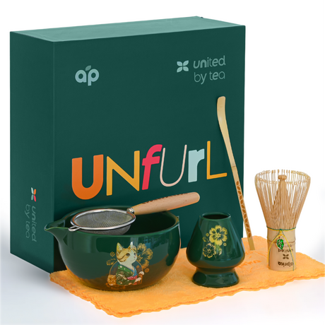 The Green Unfurl Matcha Gift Set includes a green box, matcha bowl, whisk, strainer, scoop, and clothβeach featuring delightful cat and flower designs.