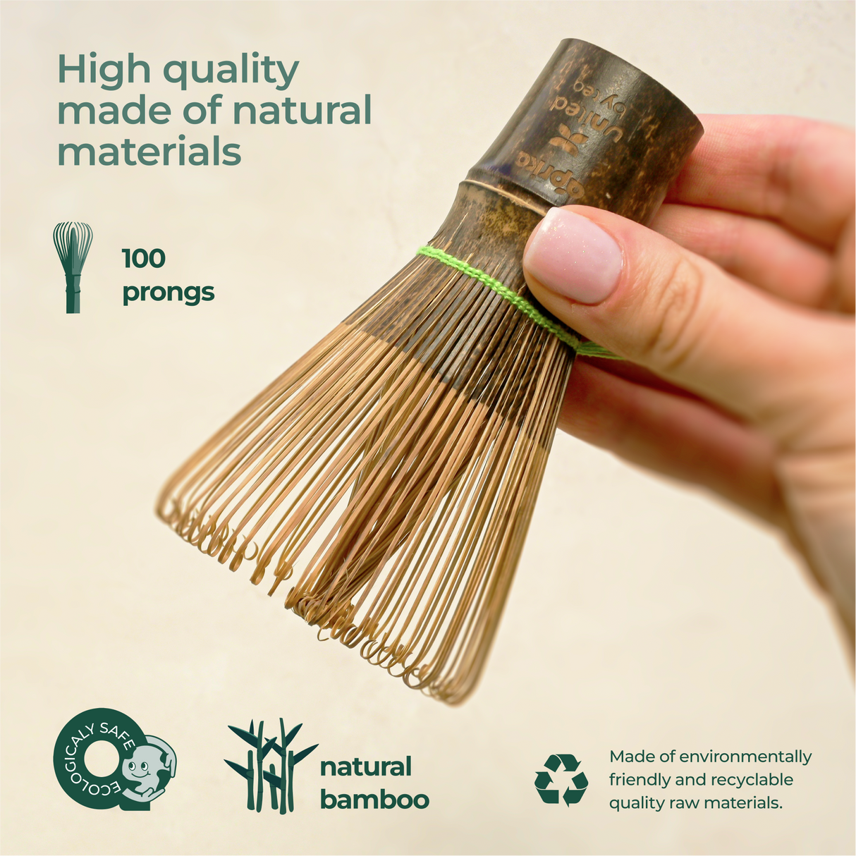 Hand holds a Dark Matcha Bamboo Whisk, crafted with 100 prongs for ceremonial Matcha tea. Eco-friendly and made from natural materials, it makes a unique gift idea.