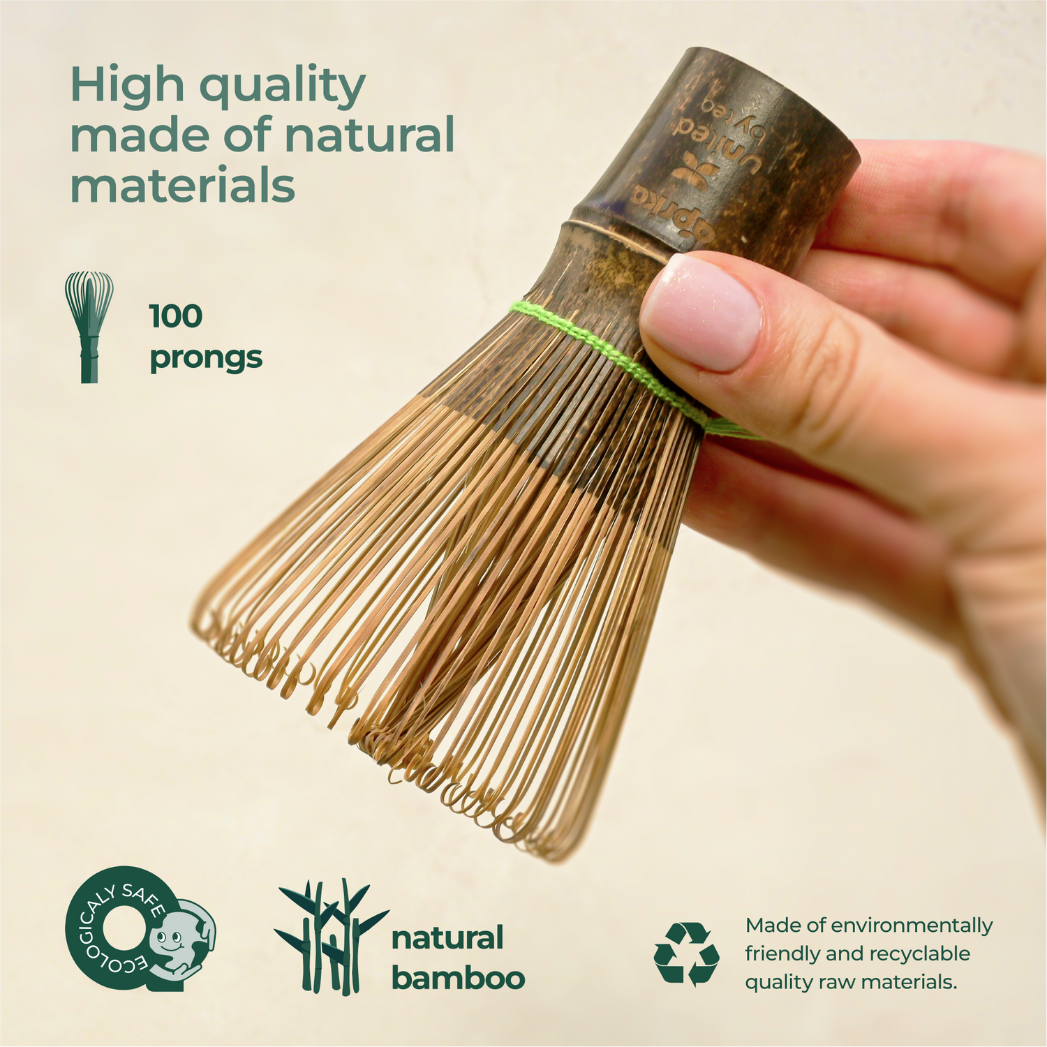 Hand holds a Dark Matcha Bamboo Whisk, crafted with 100 prongs for ceremonial Matcha tea. Eco-friendly and made from natural materials, it makes a unique gift idea.