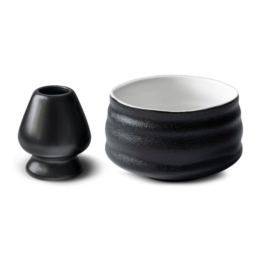 The Black Matcha Tea Gift Set includes a textured ceramic bowl, matching vase, and bamboo whisk, making it perfect for ceremonial matcha tea rituals. Displayed against a white backdrop.