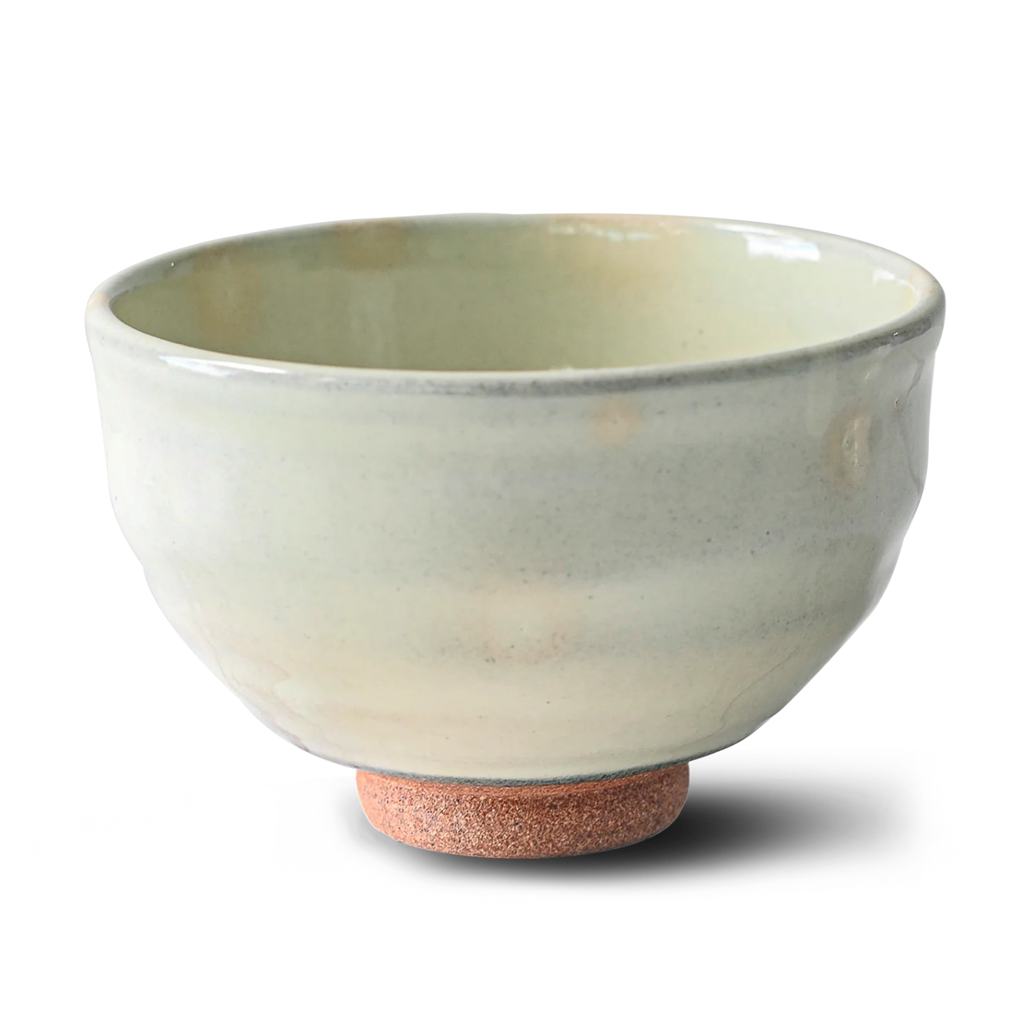 The White Kohiki Ceramic Matcha Bowl, featuring a light green glaze and textured brown base, crafted using Minoyaki pottery techniques, rests elegantly on a white background.