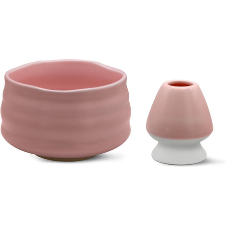 A pink ceramic matcha bowl with wavy edges and a small pink and white vase on a white background capture the elegance of the Ceremonial Matcha Starter Kit - Pink.