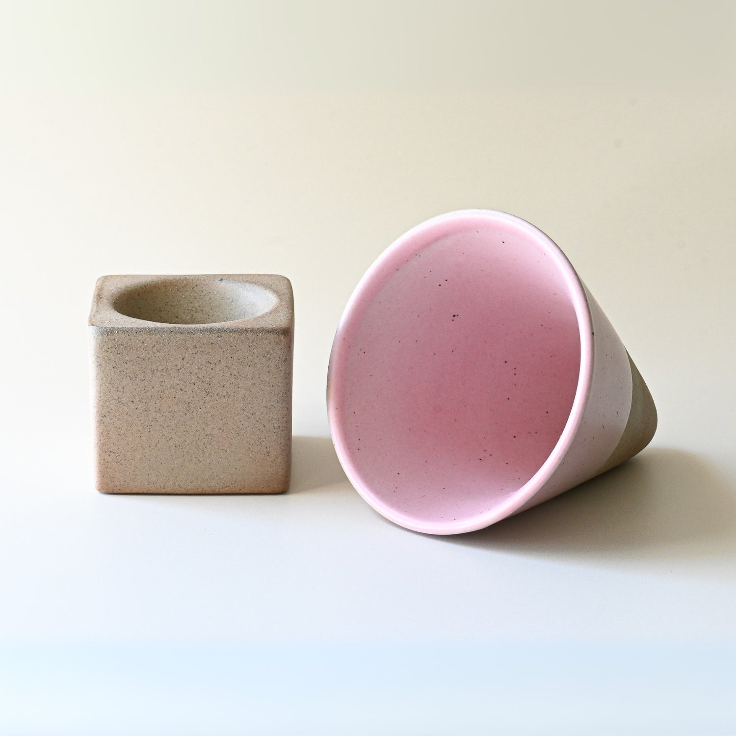 The 6.8 oz Pink Coffee Mug with its square stone base embodies the elegance of ceramic artistry on a minimalist surface.