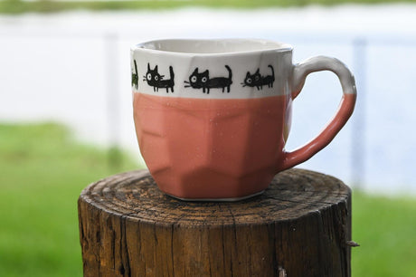 The Handmade Pink Ceramic Tea or Coffee Mug With Black Cats Print from Japan (8oz/250ml) is a charming choice for cat lovers seeking a playful, handcrafted Japanese mug.