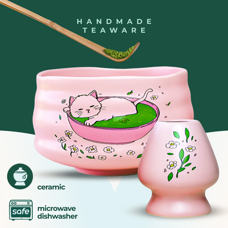 Pink Unfurl Matcha Gift Set: Includes a cat print bowl and pink ceramic teaware with floral designs. Handmade, microwave and dishwasher safe, plus a bamboo whisk for the perfect tea experience.